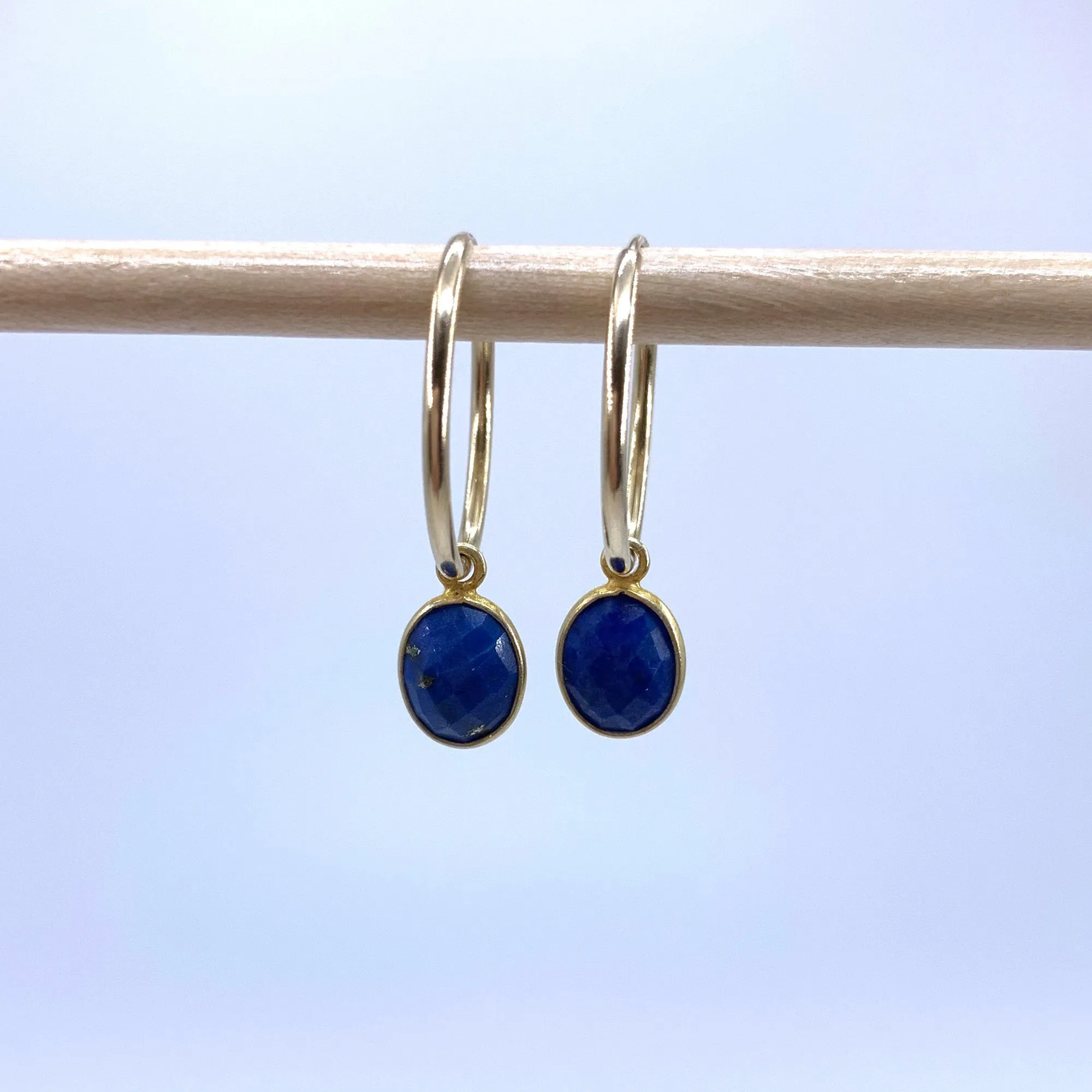 Gemstone earrings with lapis lazuli (blue) oval crystal drops on gold small hoops